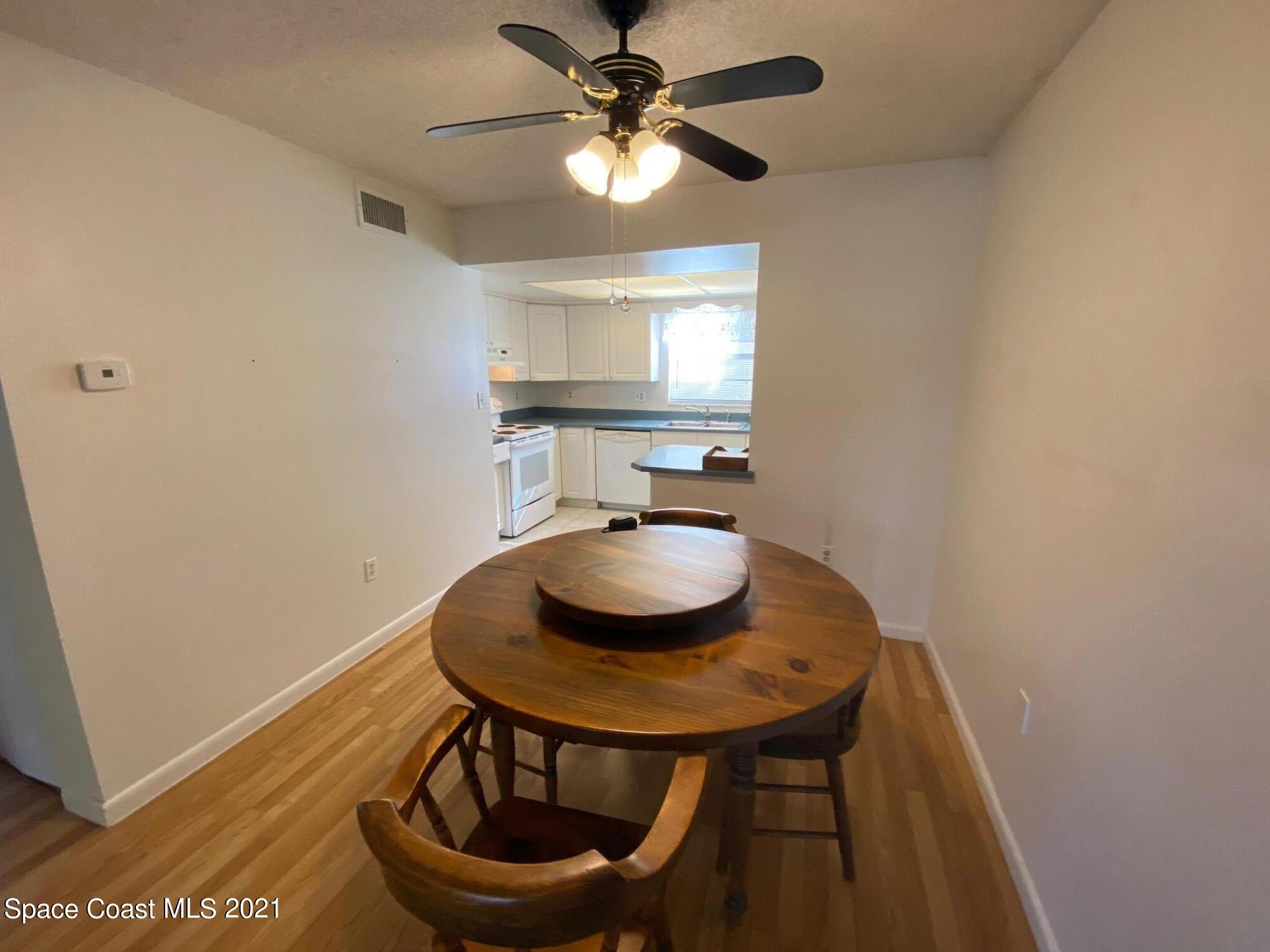 3135 Shady Dell Lane, Unit 112 Melbourne, FL 32935 - Photo 7 of 22 a dining room with furniture and window