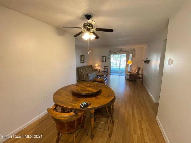 a dining room with furniture and wooden floor