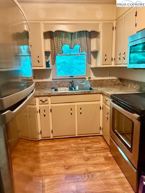 2202 Old 16 Highway Jefferson, NC 28640 - Photo 2 of 27 a kitchen with stainless steel appliances granite countertop a stove a sink and a microwave