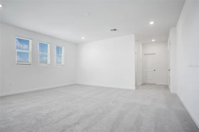 a bathroom with a bathtub shower sink vanity mirror and toilet