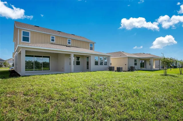 a view of a house with backyard and garden