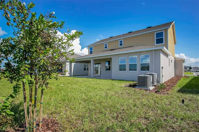 an aerial view of residential houses with outdoor space and swimming pool