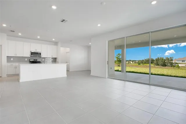 a view of kitchen with refrigerator and window