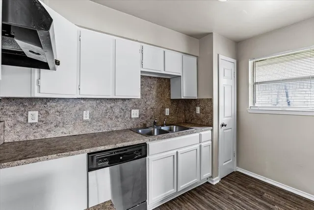 a kitchen with stainless steel appliances granite countertop a sink stove and cabinets