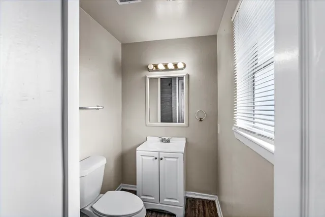 a bathroom with a toilet sink and mirror