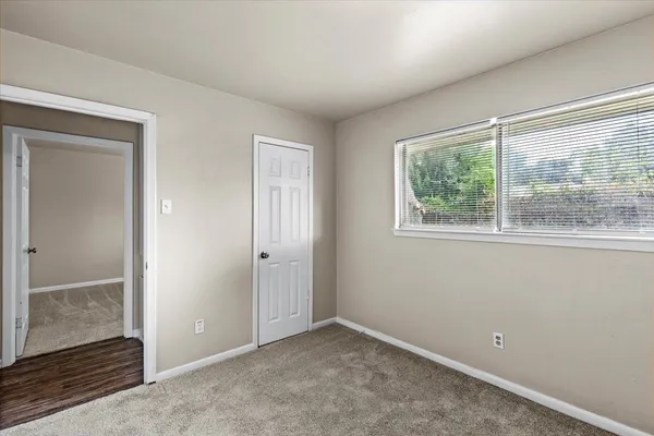 an empty room with windows and closet