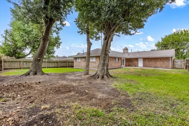 a house with green field in front of it