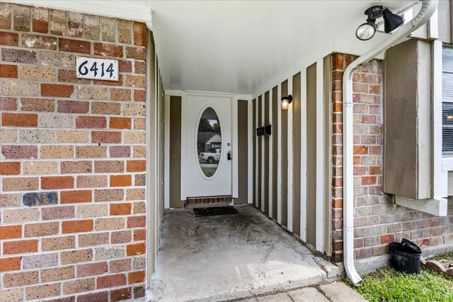 a view of a door with wooden walls