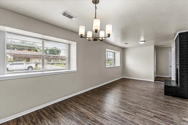 a view of a room with wooden floor staircase and a ceiling fan