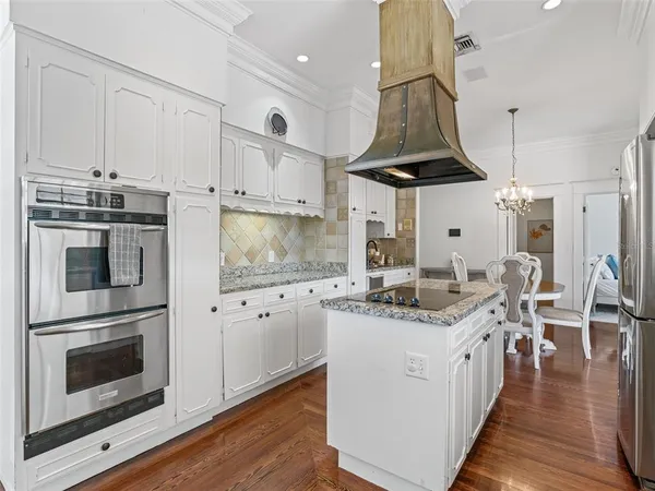 a kitchen with stainless steel appliances a stove a sink and a refrigerator