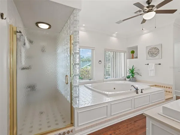 a bathroom with a tub sink and mirror