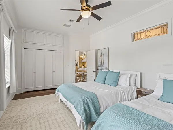 a bedroom with a bed and ceiling fan