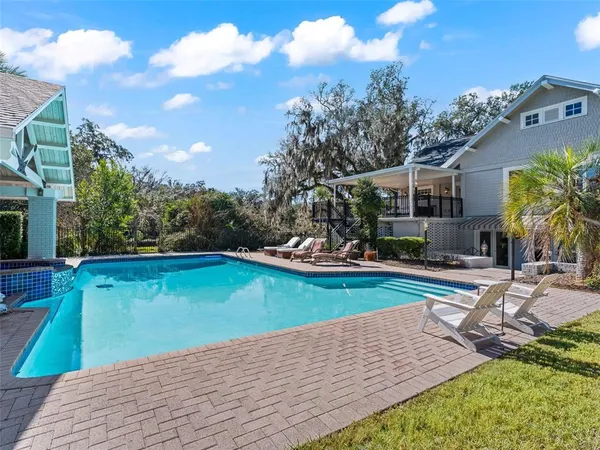 a view of a swimming pool with lounge chairs