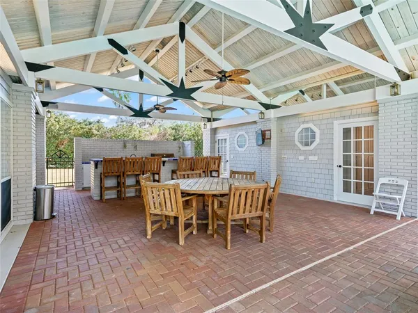 a dining room with a wooden table and chairs