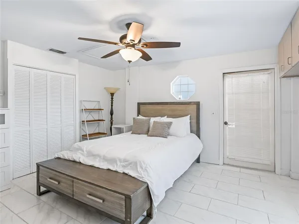 a bedroom with a bed and a chandelier