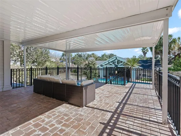 a balcony with furniture and wooden floor