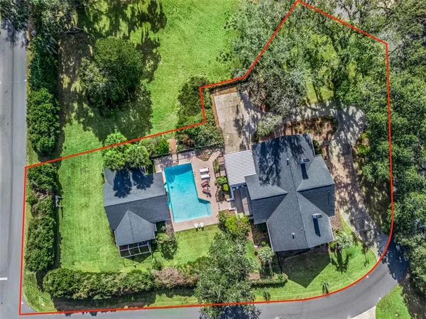 an aerial view of a house with garden space and street view