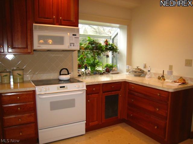 3107 Huntington Road Cleveland, OH 44120 - Photo 9 of 25 Another view of the kitchen with appliances and green house window overlooking the rear yard.