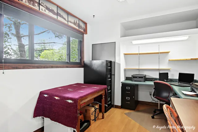 a kitchen with stainless steel appliances granite countertop a stove refrigerator a dining table and chairs a refrigerator with wooden floor