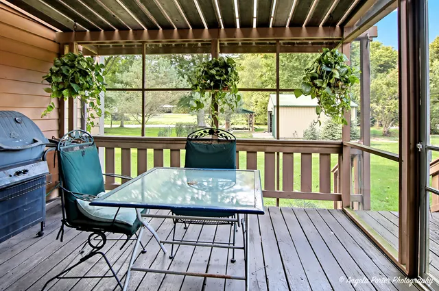 a view of a chairs and table in the balcony