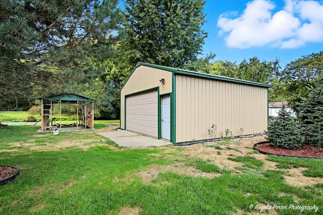 a backyard of a house with table and chairs