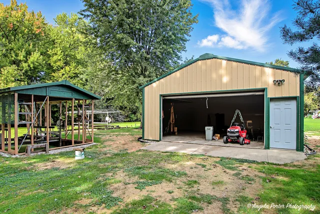 a view of a house with yard and sitting area