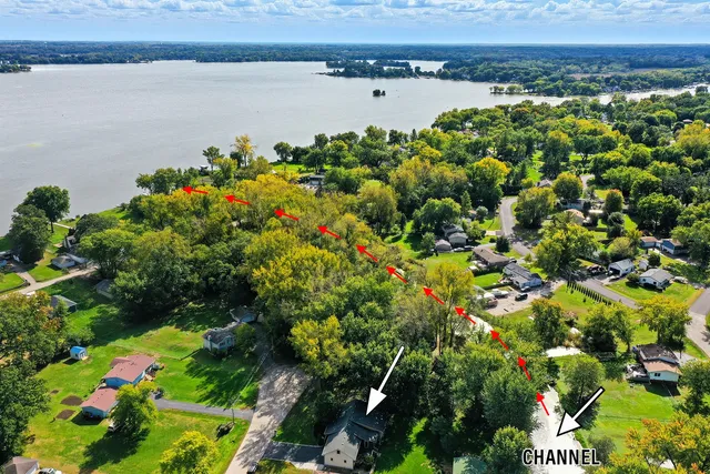 a view of a lake with a flower garden