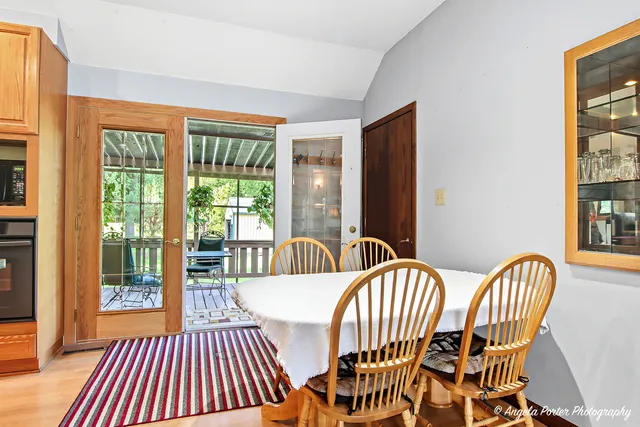 a view of a dining room with furniture wooden floor and windows