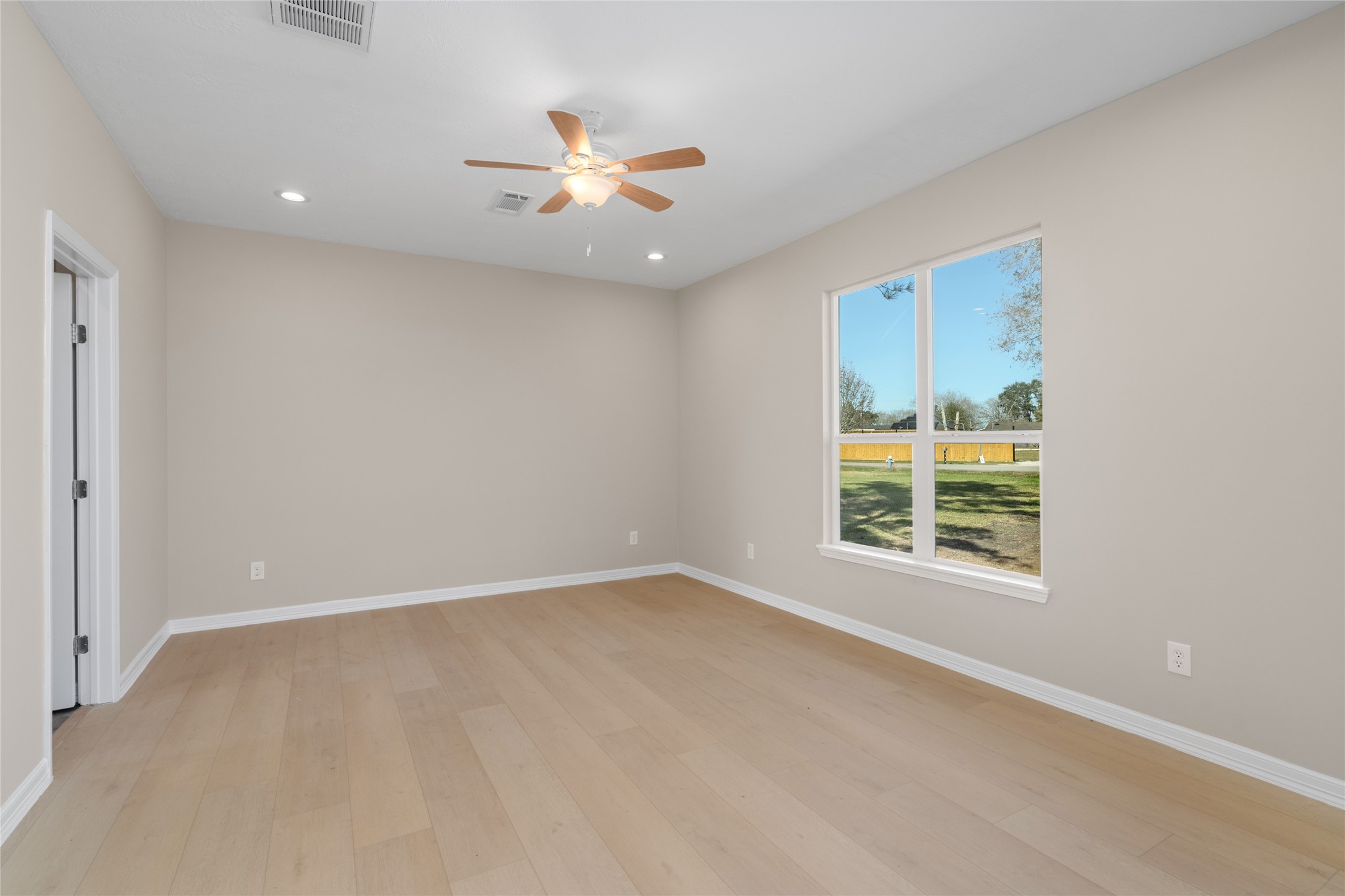 4654 North Teague Street Rosharon, TX 77583 - Photo 28 of 46 A sun-soaked bedroom with
large windows invites restful
nights and peaceful
mornings, offering both
comfort and tranquility.