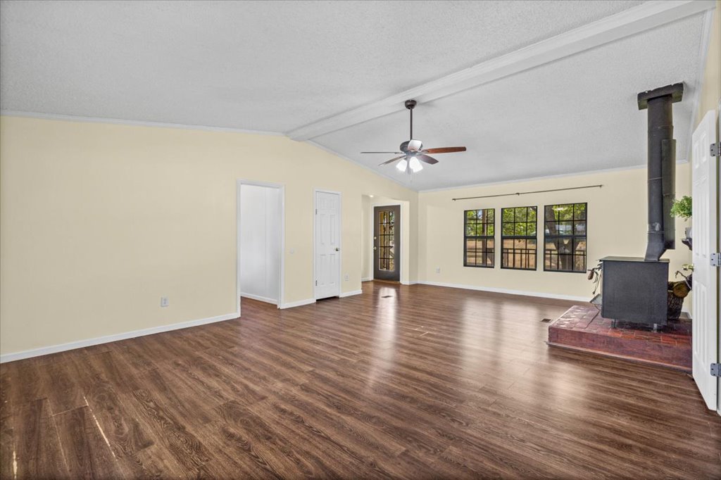 13501 Nutty Brown Road, Unit B Austin, TX 78737 - Photo 7 of 29 Hardwood floors and a cozy wood-burning fireplace create a comfortable living space.