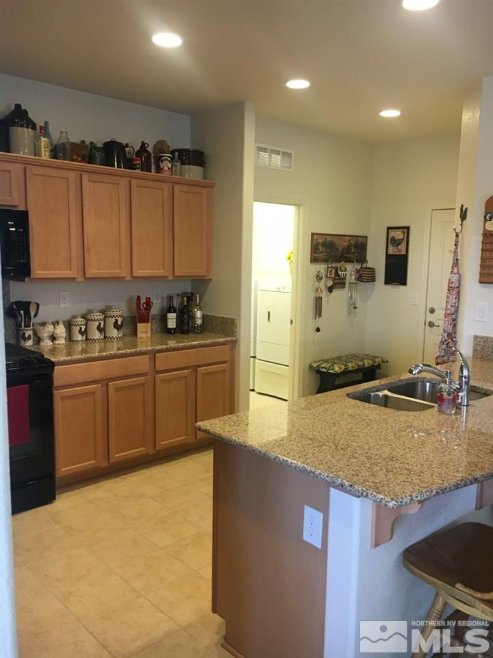 9236 Maplehurst Trail Reno, NV 89523 - Photo 14 of 25 a kitchen with a sink a stove and a refrigerator