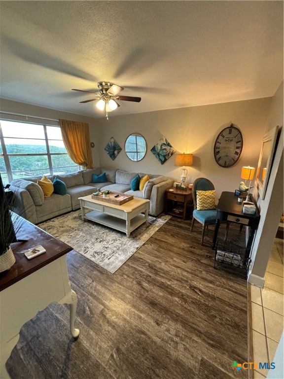 a living room with furniture a clock and a large window