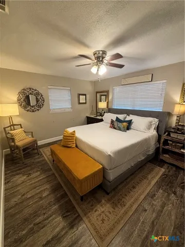 a bedroom with a large bed and a chandelier