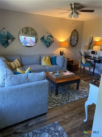 a living room with furniture a rug and a window