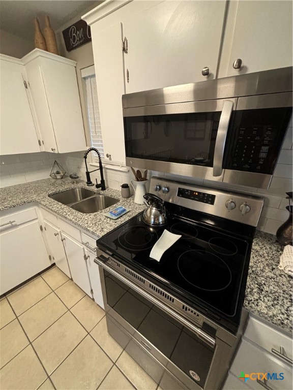 1307 Sherry Lane, Unit B Copperas Cove, TX 76522 - Photo 27 of 48 a kitchen with a stove and a sink