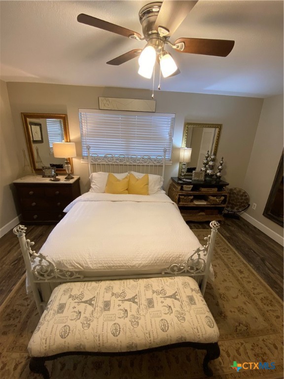 1307 Sherry Lane, Unit B Copperas Cove, TX 76522 - Photo 40 of 48 a bed sitting in a bedroom next to a lamp