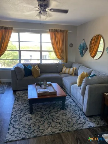 a bedroom with a bed and a ceiling fan