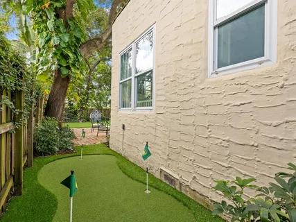 a view of a backyard with plants and a swimming pool