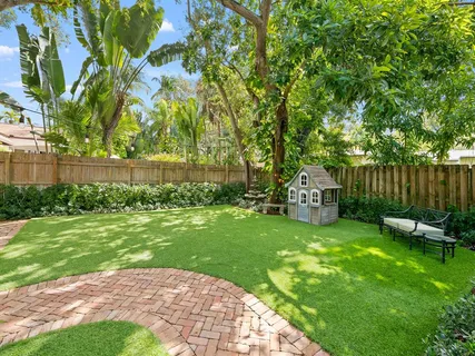 a backyard of a house with table and chairs