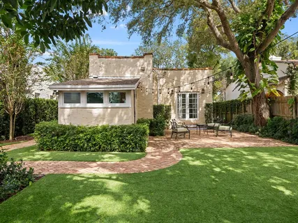 a view of a house with backyard and sitting area