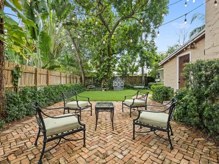 a view of a chairs and table in backyard of the house