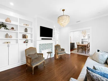 a living room with fireplace furniture and a flat screen tv