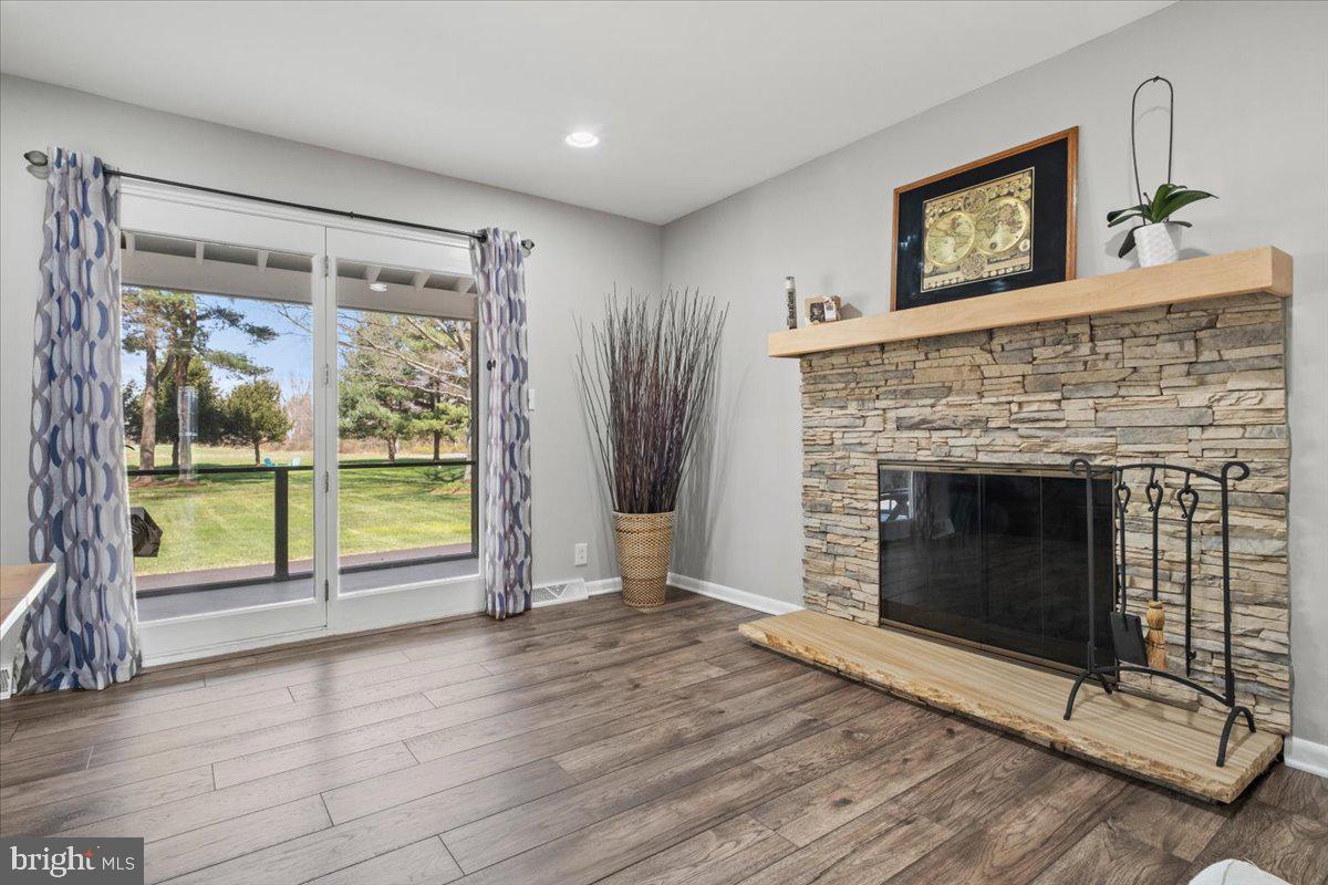 40 New Freedom Road Monroeville, NJ 08343 - Photo 20 of 51 a living room with a fireplace and a floor to ceiling window