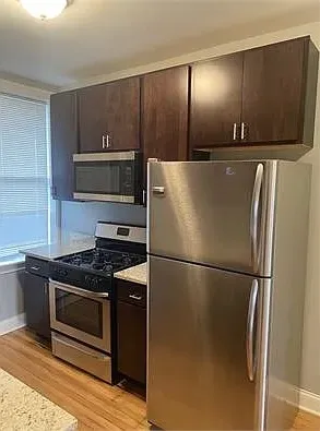 a kitchen with a refrigerator and a stove