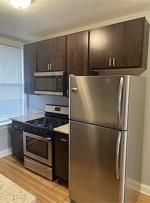 4501 West Maypole Avenue Chicago, IL 60624 - Photo 3 of 13 a kitchen with a refrigerator and a stove