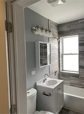 4501 West Maypole Avenue Chicago, IL 60624 - Photo 6 of 13 a bathroom with a sink a toilet and shower