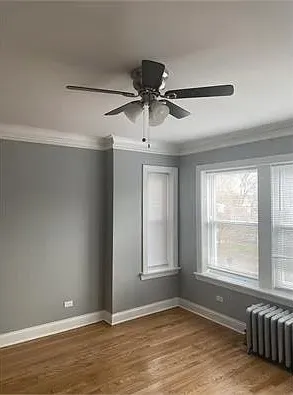 a view of a livingroom with a ceiling fan and window