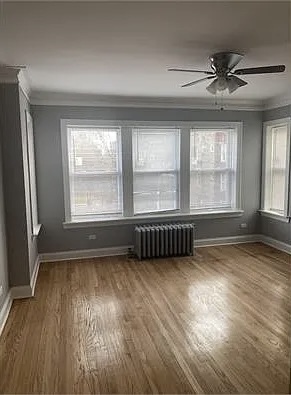 4501 West Maypole Avenue Chicago, IL 60624 - Photo 9 of 13 an empty room with wooden floor and windows