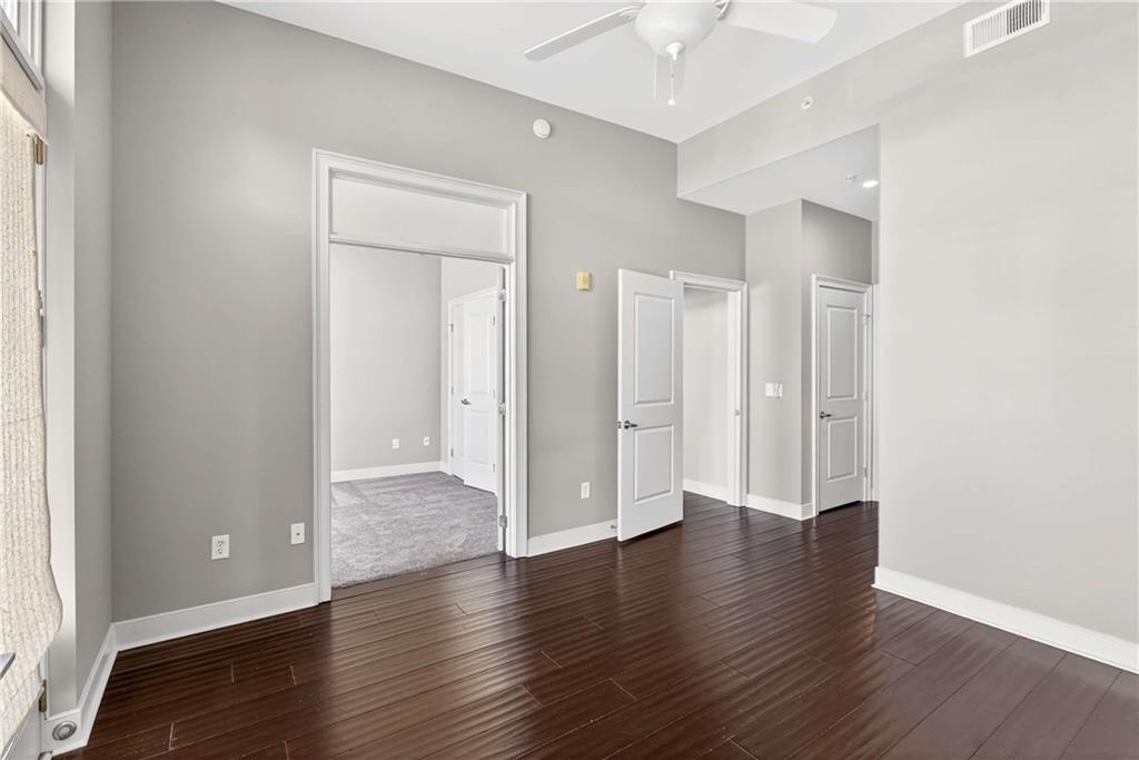 201 West Ponce De Leon Avenue, Unit 702 Decatur, GA 30030 - Photo 12 of 41 a view of an empty room with wooden floor and a window