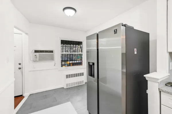 a kitchen with refrigerator and window